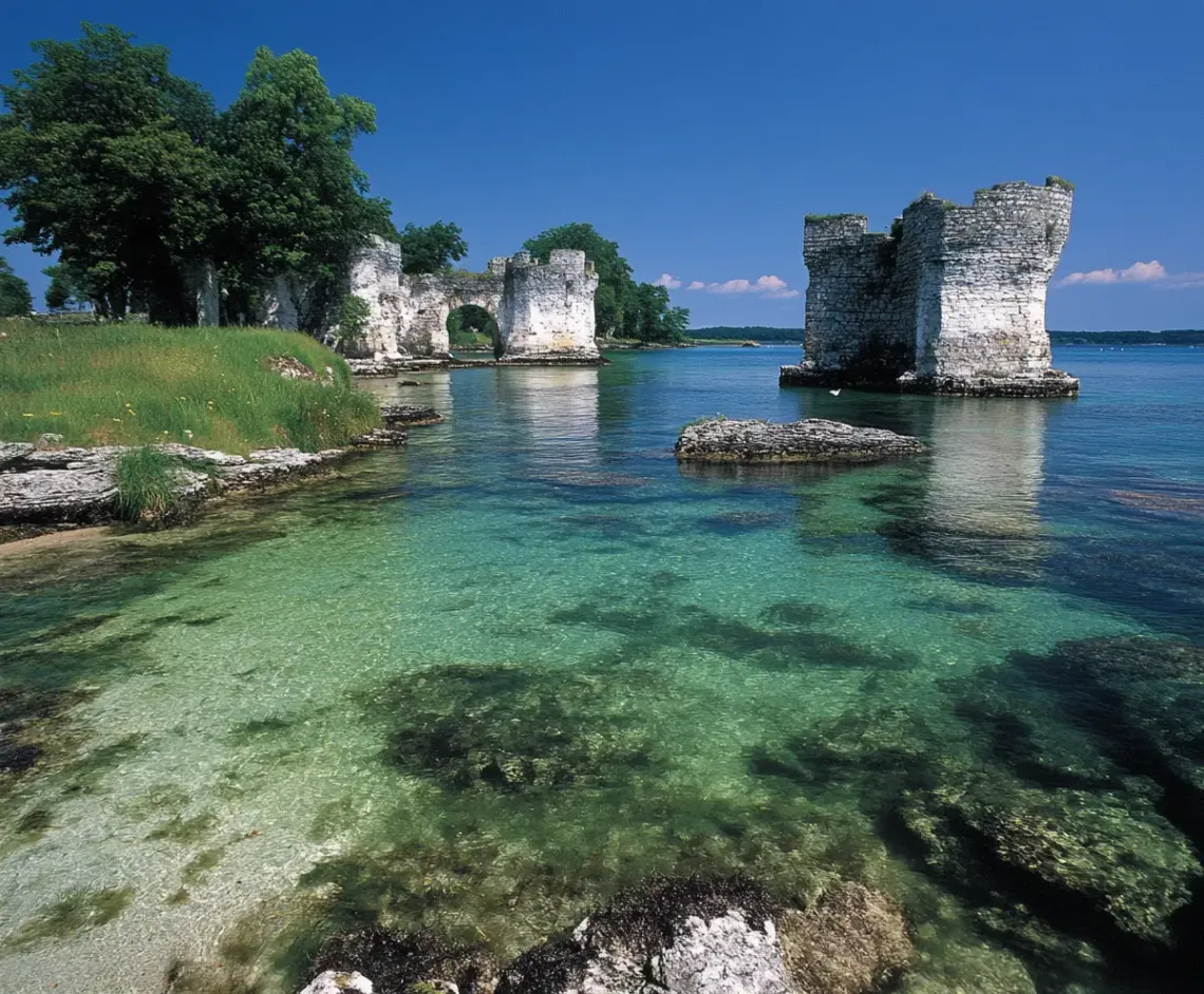 Majestic castle standing tall beside a serene body of water with a beautiful reflection.