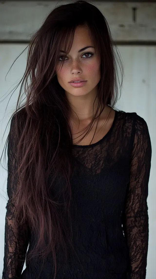 High fashion photo of a woman with long brown hair.